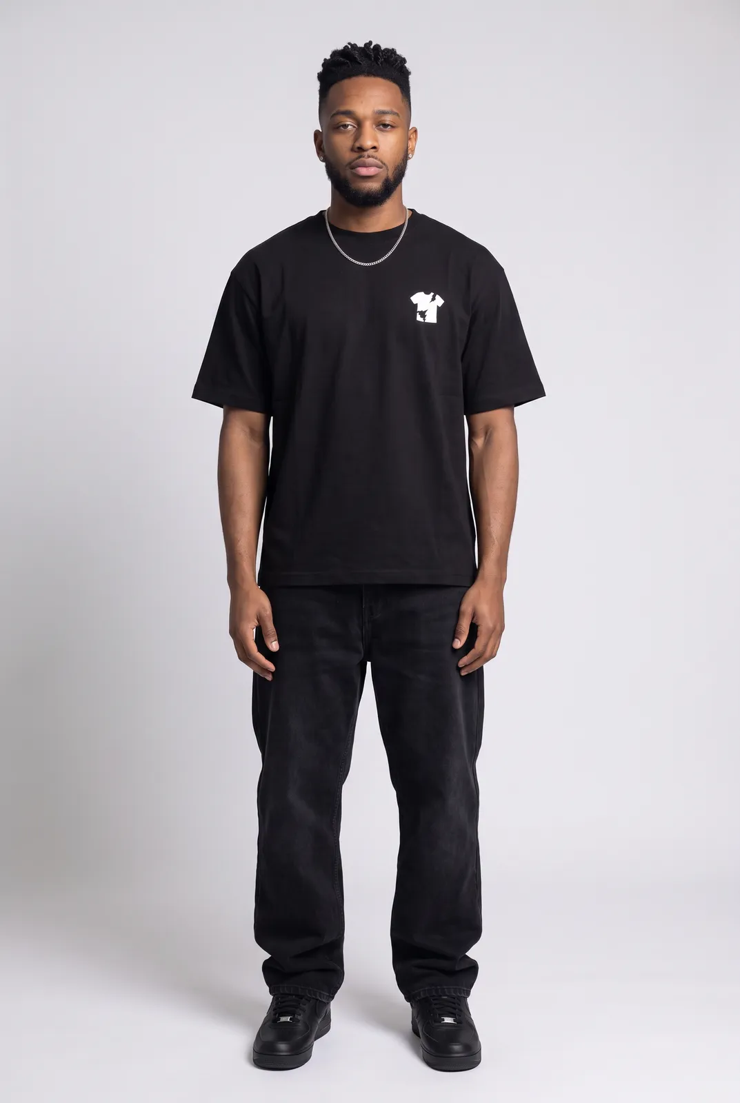 Malik Carter wearing the BLACKOUT Oversized in Black, front hero